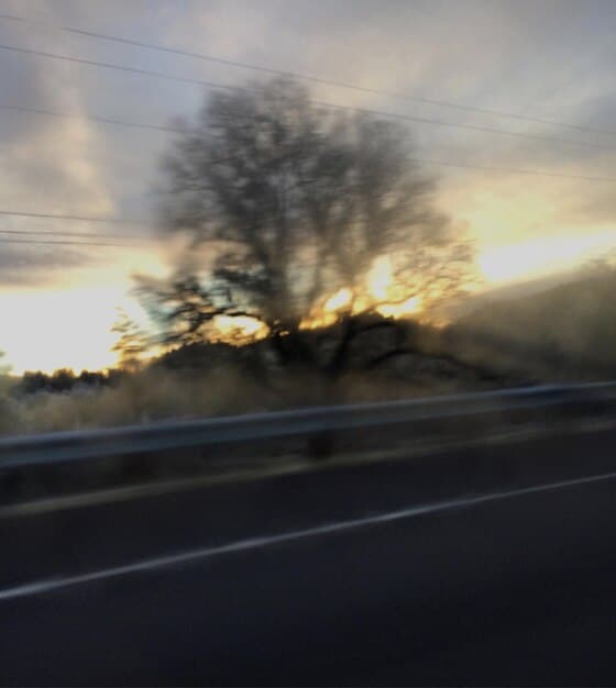 A blurry and distorted image of a road as seen through an AR navigation app, illustrating potential issues with visibility and accuracy in adverse weather conditions or due to technical glitches.