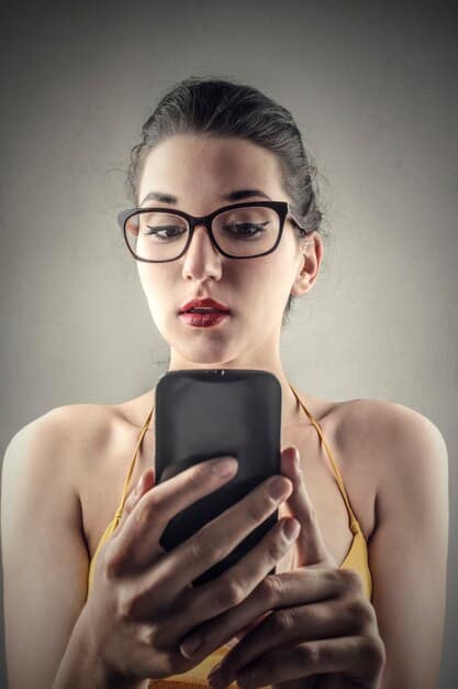 A close-up shot of a woman using her smartphone to virtually try on different pairs of sunglasses. The AR overlay is seamless, showing how the sunglasses fit her face perfectly.