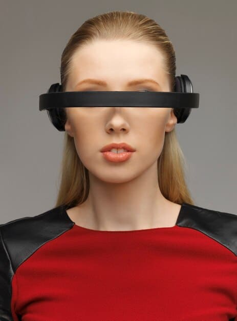A close-up of bone conduction headphones, highlighting the transducers and their placement on the cheekbones, with a blurred background showing someone using a VR headset.