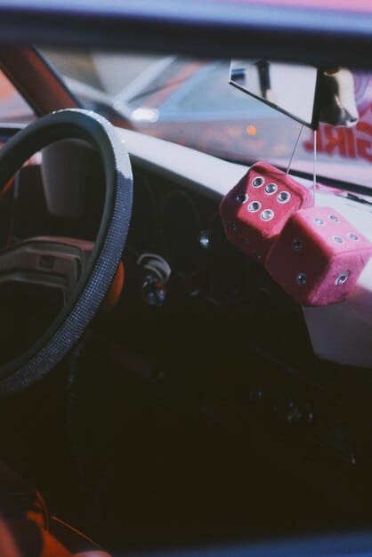 A screenshot from inside a race car in Assetto Corsa VR showing the dashboard and steering wheel, highlighting the realistic textures and lighting within the virtual cockpit.